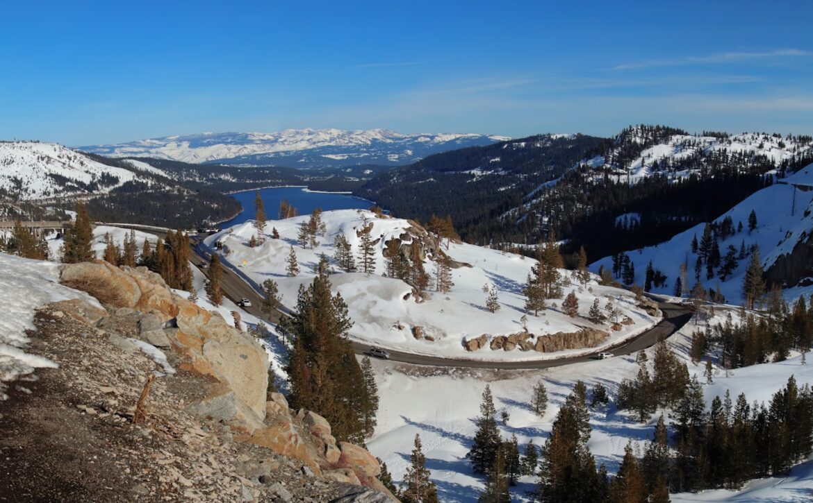 a view of a snowy mountain with a train on the tracks