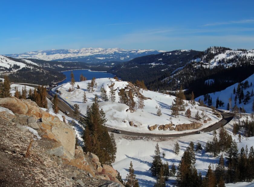 a view of a snowy mountain with a train on the tracks
