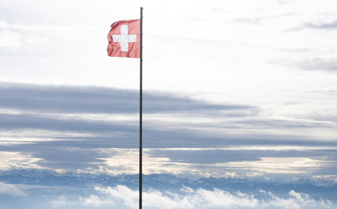 A red flag on top of a tall pole