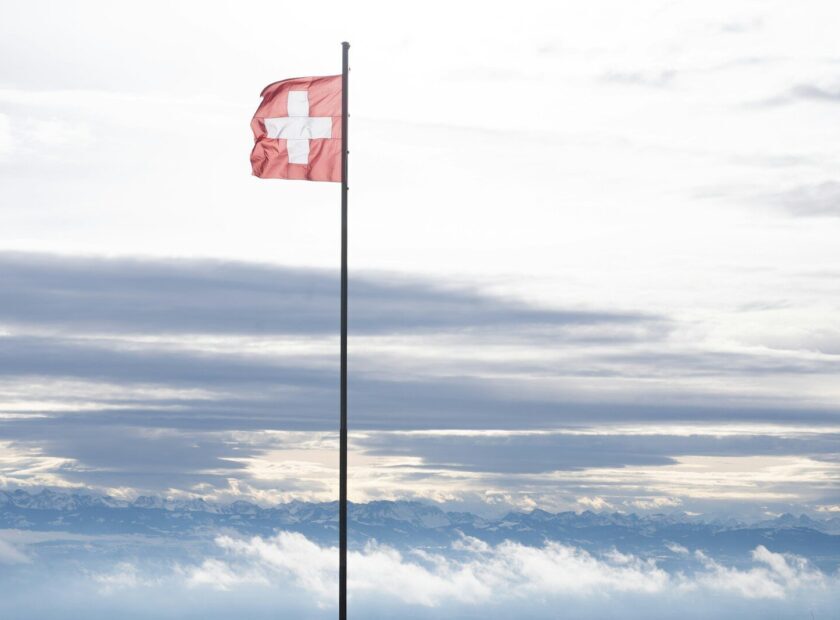 A red flag on top of a tall pole