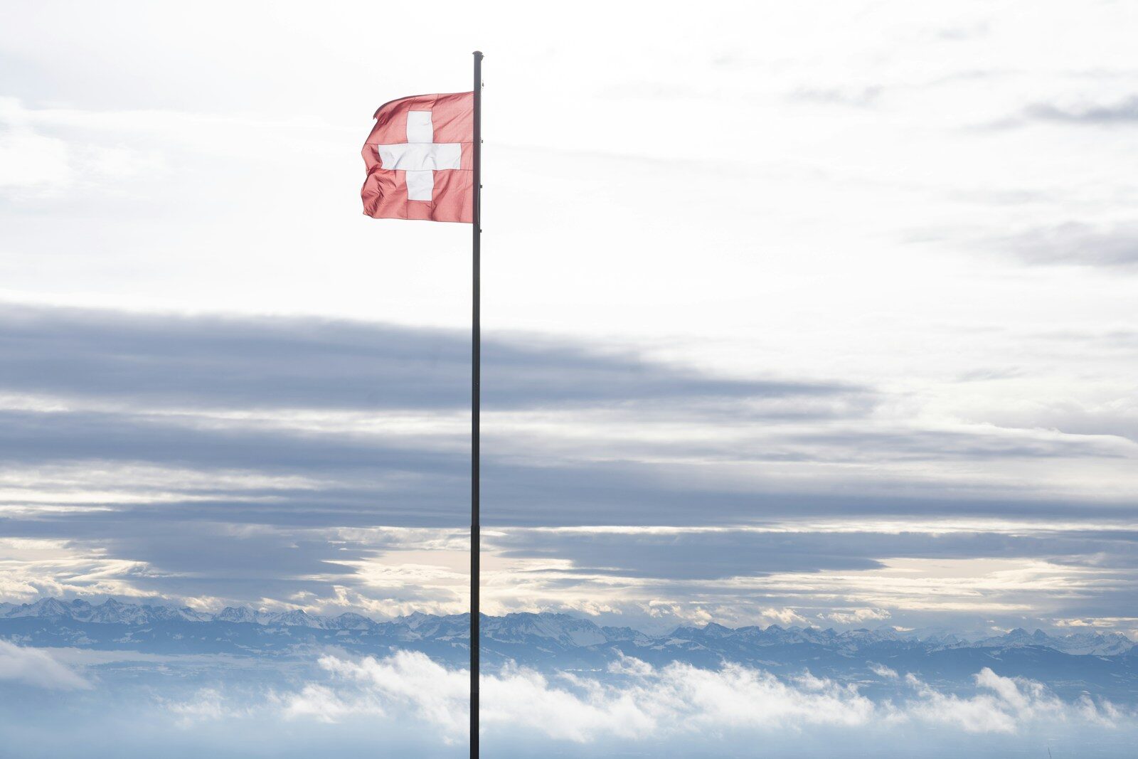 A red flag on top of a tall pole